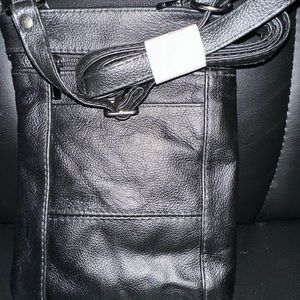 Leather bag features 3 front zip pockets